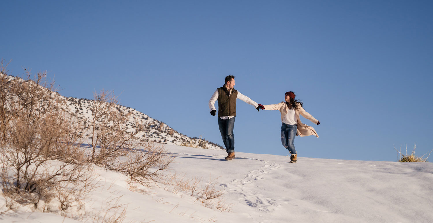 Winter engagement session with snowy mountain backdrop