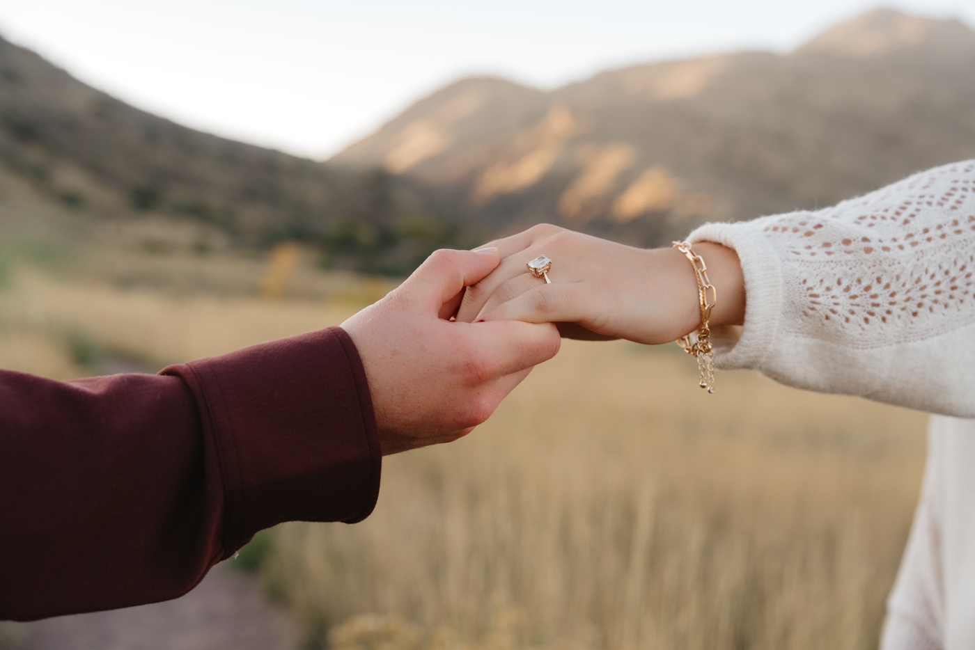 Engaged couple holding hands