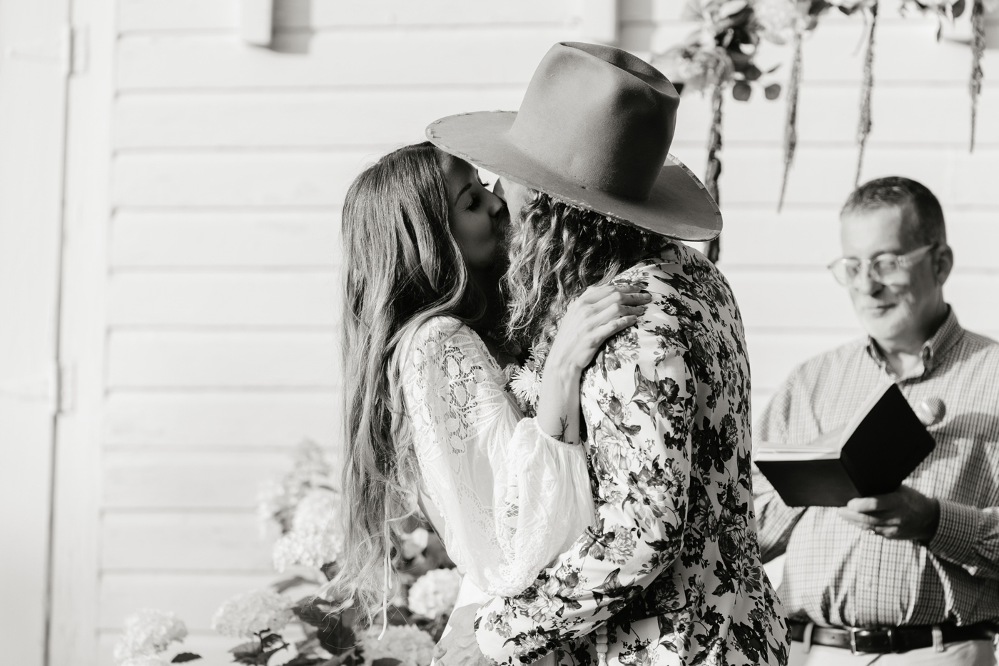 Bride and groom sharing their first kiss as a married couple