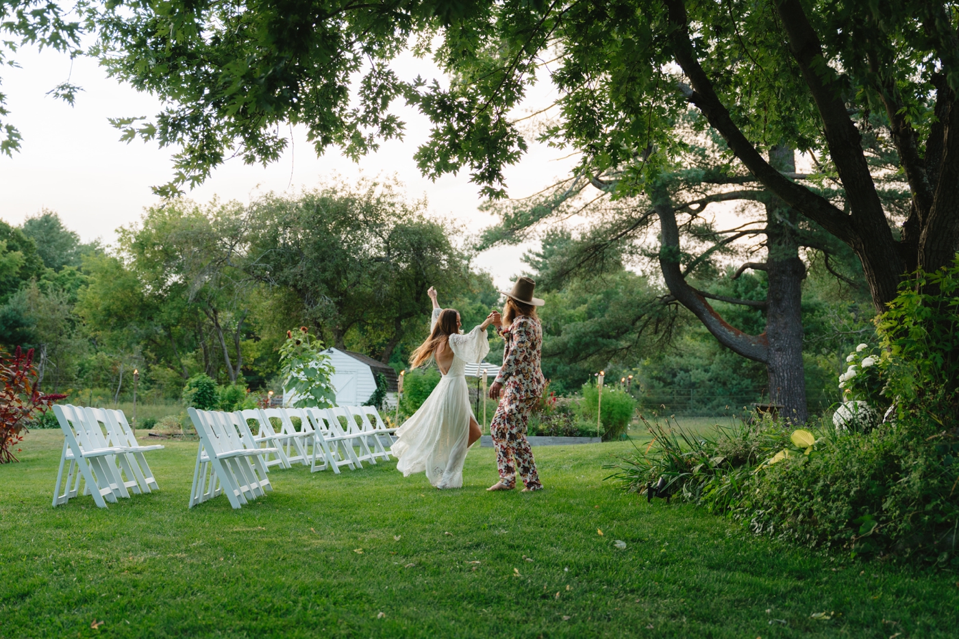 Bride and groom dancing in their garden