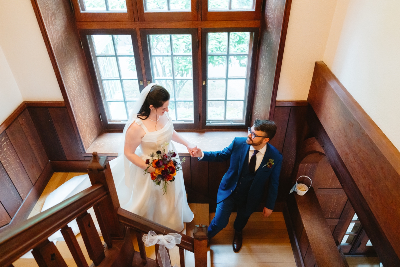 Bride and groom walking up the stairs